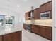 Well-equipped kitchen with granite counters, modern appliances, and dark wood cabinets at 5312 Meadow Hill Loop, Lady Lake, FL 32159