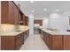 Spacious kitchen featuring granite countertops, stainless appliances, and dark wood cabinetry at 5312 Meadow Hill Loop, Lady Lake, FL 32159
