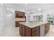 Island kitchen with granite countertops and wine cooler at 5312 Meadow Hill Loop, Lady Lake, FL 32159