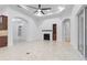 Spacious living room with fireplace, arched doorways, tile flooring, and a modern ceiling fan at 5312 Meadow Hill Loop, Lady Lake, FL 32159
