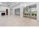 Open living space with fireplace and access to patio at 5312 Meadow Hill Loop, Lady Lake, FL 32159