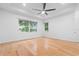 Bright main bedroom featuring hardwood floors, recessed lighting, ceiling fan and large windows at 5312 Meadow Hill Loop, Lady Lake, FL 32159