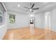 Large main bedroom with hardwood floors, tray ceiling, ceiling fan, and ensuite bathroom at 5312 Meadow Hill Loop, Lady Lake, FL 32159