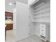 Spacious walk-in pantry with adjustable shelving and built-in drawers for optimal storage in kitchen at 5312 Meadow Hill Loop, Lady Lake, FL 32159