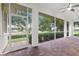 Spacious screened porch with paver floor and view of backyard at 5312 Meadow Hill Loop, Lady Lake, FL 32159