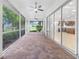 Screened porch with pavers, multiple ceiling fans, and view of golf course at 5312 Meadow Hill Loop, Lady Lake, FL 32159