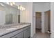 Double vanity bathroom with granite countertop and walk-in shower at 5792 Timber Meadow Way, St Cloud, FL 34771