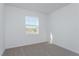 Spacious bedroom with a large window and carpeted floor at 5792 Timber Meadow Way, St Cloud, FL 34771
