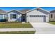 Curb appeal abounds in this charming single story home featuring a two car garage and lush landscaping at 5792 Timber Meadow Way, St Cloud, FL 34771