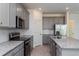 Gray shaker cabinets, granite countertops, and stainless steel appliances at 5792 Timber Meadow Way, St Cloud, FL 34771