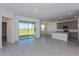 Open concept kitchen with island, gray cabinets, stainless steel appliances and view of backyard at 5792 Timber Meadow Way, St Cloud, FL 34771
