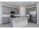 Modern kitchen with gray cabinets, granite countertops and stainless steel appliances at 5792 Timber Meadow Way, St Cloud, FL 34771