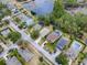 Aerial view of homes and neighborhood near a lake at 5812 Ansley Way, Mount Dora, FL 32757
