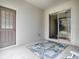 Covered patio with access door and view to backyard at 5812 Ansley Way, Mount Dora, FL 32757