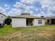 View of backyard with grassy area and patio with chair, all within a fenced perimeter at 5812 Ansley Way, Mount Dora, FL 32757