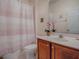 Cozy bathroom with a vanity, shower, and decorative plant accents at 5812 Ansley Way, Mount Dora, FL 32757