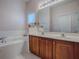 Double vanity bathroom with a soaking tub and shower at 5812 Ansley Way, Mount Dora, FL 32757