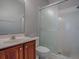 Bathroom features a shower with glass doors and wood vanity at 5812 Ansley Way, Mount Dora, FL 32757