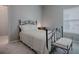 Cozy bedroom featuring a decorative bed frame, bench, and a bright window at 5812 Ansley Way, Mount Dora, FL 32757