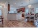 Open concept dining area with hardwood floors and kitchen view at 5812 Ansley Way, Mount Dora, FL 32757