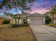 Attractive single-story home with a two-car garage and manicured lawn at 5812 Ansley Way, Mount Dora, FL 32757