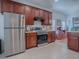 Bright kitchen with stainless steel appliances, tile flooring, and ample counter space at 5812 Ansley Way, Mount Dora, FL 32757