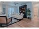 Bright living room with hardwood floors, comfy seating, and built-in shelving at 5812 Ansley Way, Mount Dora, FL 32757