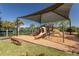 Community playground with slides and shade covering with bench seating at 5812 Ansley Way, Mount Dora, FL 32757