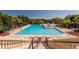 Resort-style swimming pool and sun deck with mature trees and lounge seating at 5812 Ansley Way, Mount Dora, FL 32757