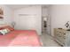 Spacious bedroom with coral bedding, double doors and dresser at 5867 Marsh Ct, The Villages, FL 32163