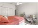 Bright bedroom with coral bedding, double doors, and a cozy armchair at 5867 Marsh Ct, The Villages, FL 32163