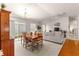 Bright dining area with a wooden table and access to the backyard at 5867 Marsh Ct, The Villages, FL 32163
