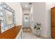 Entryway with mirror, console table, and vase of flowers at 5867 Marsh Ct, The Villages, FL 32163