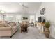 Comfortable living room featuring beige sofas and a coffee table at 5867 Marsh Ct, The Villages, FL 32163