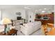 Open living room and kitchen with neutral colors and comfortable furniture at 5867 Marsh Ct, The Villages, FL 32163