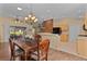 Bright dining room with hardwood floors and a chandelier at 7080 Se 173Rd Arlington Loop, The Villages, FL 32162