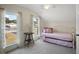Bedroom with twin bed, nightstand, and two windows at 7206 Earlwood Ave, Mount Dora, FL 32757