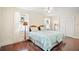Bright bedroom with twin beds, stained wood floors, and window seating at 7206 Earlwood Ave, Mount Dora, FL 32757