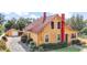 Charming yellow house with red trim, large yard, and detached garage at 7206 Earlwood Ave, Mount Dora, FL 32757