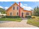 Yellow house with red trim, brick chimney and walkway at 7206 Earlwood Ave, Mount Dora, FL 32757