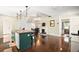 Spacious kitchen with island, hardwood floors, and stained glass window at 7206 Earlwood Ave, Mount Dora, FL 32757