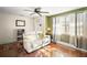Living room with white couch, hardwood floors, and ceiling fan at 7206 Earlwood Ave, Mount Dora, FL 32757