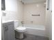 Well-maintained bathroom featuring a shower-tub combo with tile surround and gray vanity at 723 Perkins St # 104, Leesburg, FL 34748