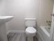 Clean bathroom featuring a pedestal sink, toilet, and tub with tiled walls at 723 Perkins St # 104, Leesburg, FL 34748
