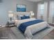 Bright bedroom features a white platform bed with blue accents and matching bedside tables at 723 Perkins St # 104, Leesburg, FL 34748