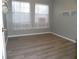 Cozy bedroom with wood-look flooring, neutral walls, natural light, and an open closet at 723 Perkins St # 104, Leesburg, FL 34748