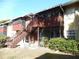 The back exterior of the house features a screened porch with wooden railings and stairs at 723 Perkins St # 104, Leesburg, FL 34748