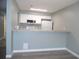 Kitchen area with breakfast bar, white cabinets, neutral countertops, and new appliances at 723 Perkins St # 104, Leesburg, FL 34748