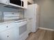 Bright kitchen with white appliances, granite countertops and modern flooring at 723 Perkins St # 104, Leesburg, FL 34748