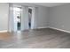 Bright living room with sliding glass doors to patio, modern flooring and neutral paint at 723 Perkins St # 104, Leesburg, FL 34748